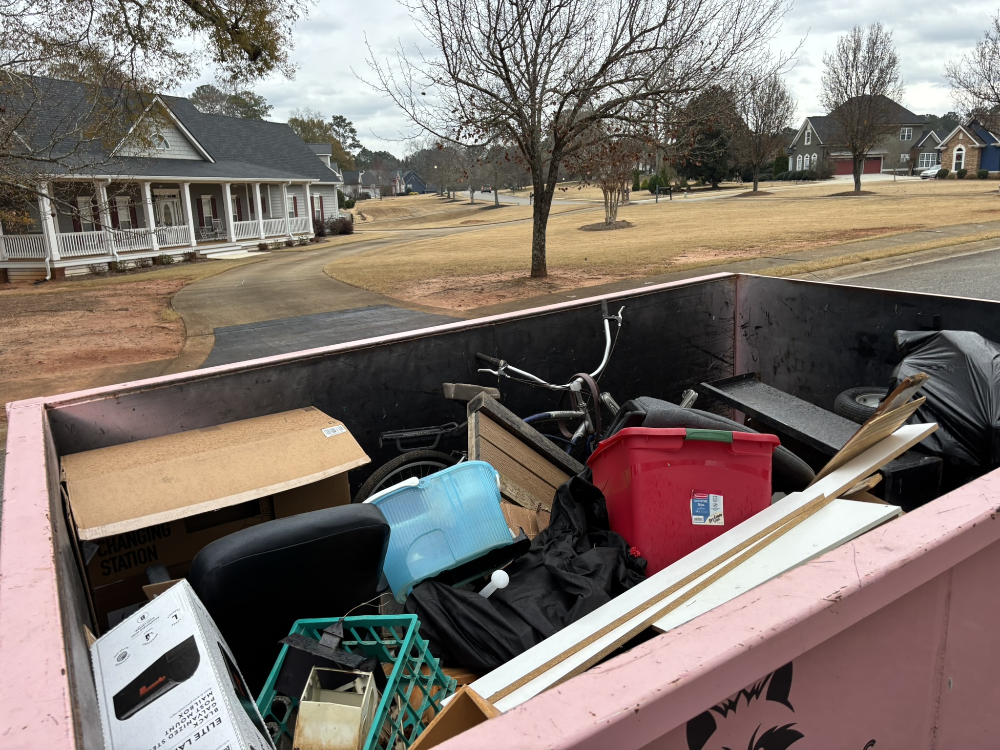 Little Junker dumpster filled with household items from a residential cleanout