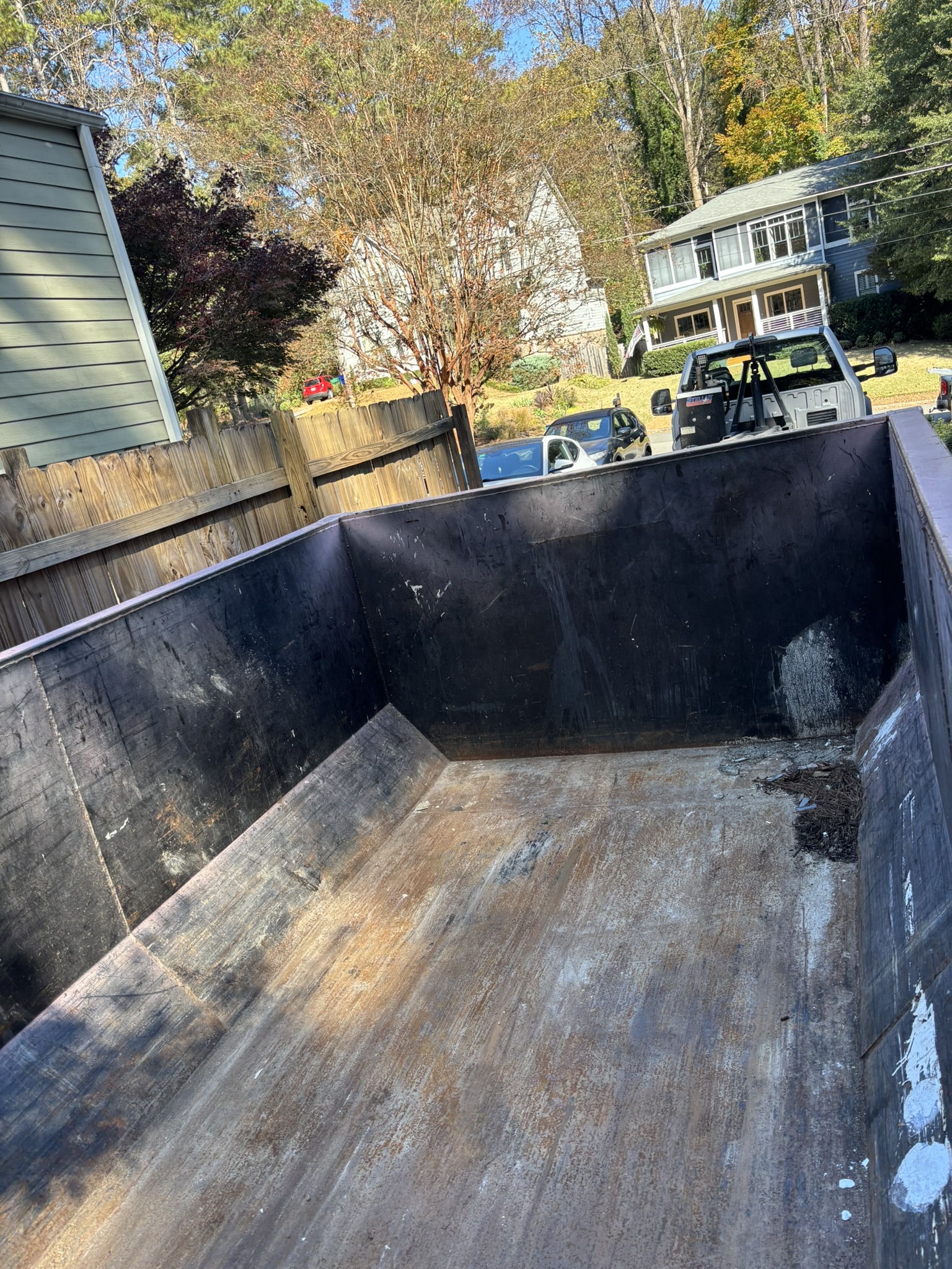 Interior of an empty Little Junker roll-off dumpster showing the open loading area